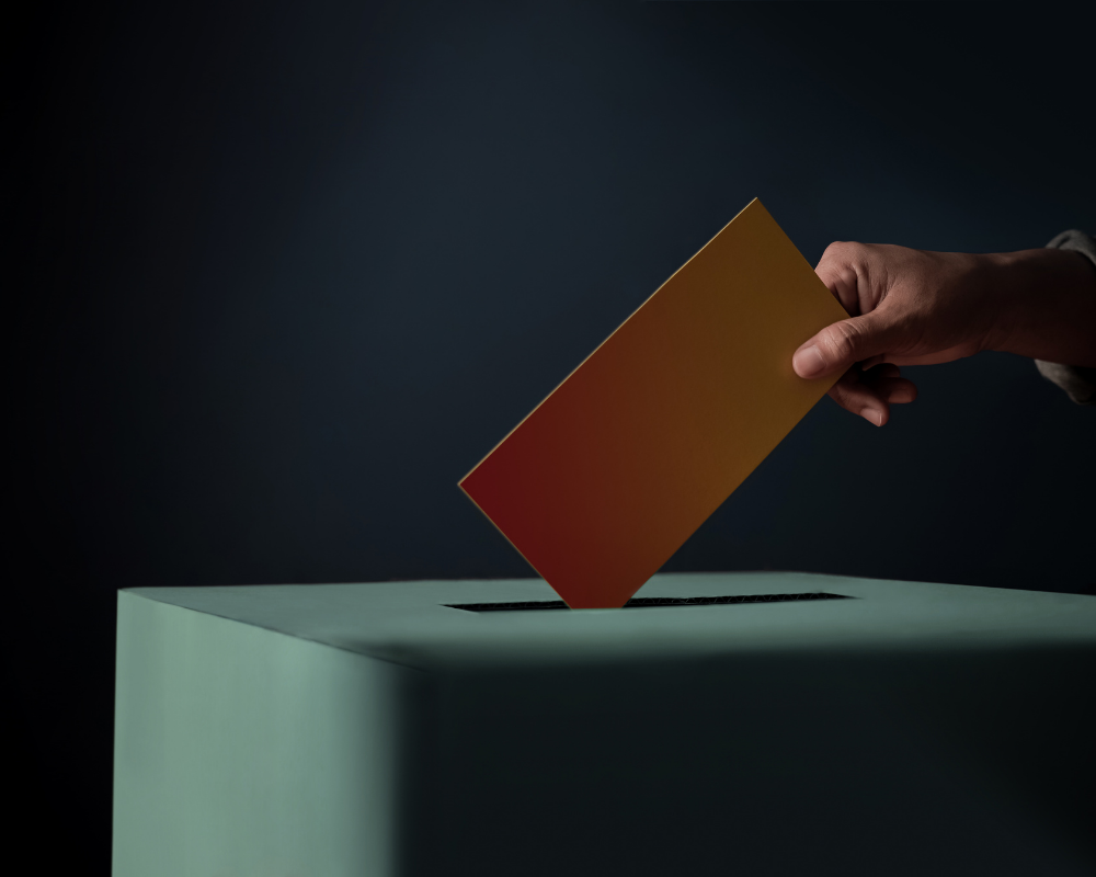 eine Stimme wird in die Wahlurne geworfen