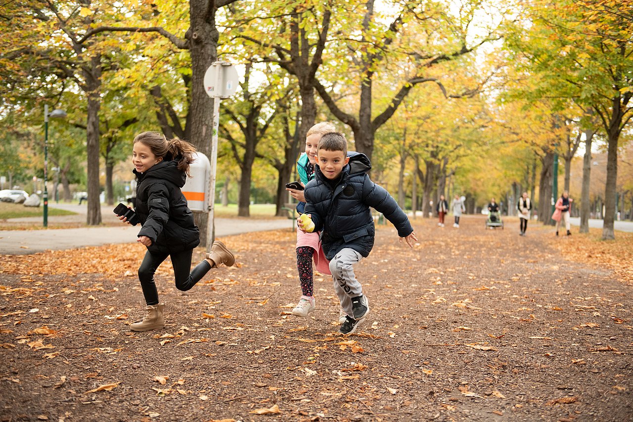 Rätselrallye 3 Kinder laufen im Freien